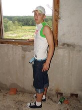 Jorts and baseball cap stylish twink posing half-naked