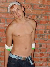 Jorts and baseball cap stylish twink posing half-naked
