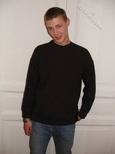 Brown-haired twink smiling and posing on the floor