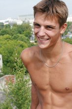 Cheerful dark-haired twink showing off his toned ass