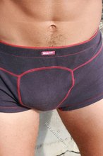 Cheerful dark-haired twink showing off his toned ass