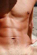 Tanned twink with sneakers showing off his body outdoors