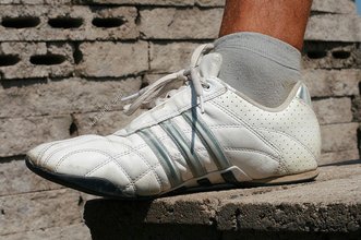 Tanned twink with sneakers showing off his body outdoors