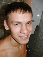 Dark-haired twink posing in the bed and showing feet