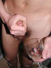 Big-dicked young boy cums inside of a glass in the bathroom