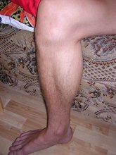 Twink licking his own biceps and showing hairy cock