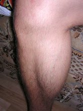 Twink licking his own biceps and showing hairy cock