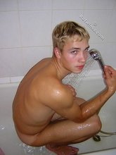 Twink licking his own biceps and showing hairy cock
