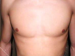 Skinny brunette twink shows his half-hard cock up close