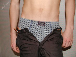 Brown-haired twink boy undressing and showing his hairy cock