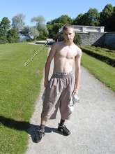 Young-looking blonde twink whips out his cock outdoors