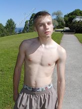 Young-looking blonde twink whips out his cock outdoors