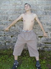 Young-looking blonde twink whips out his cock outdoors