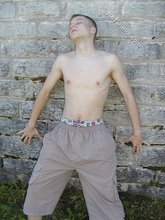 Young-looking blonde twink whips out his cock outdoors