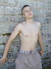 Blue-eyed and baby-faced twink undressing outdoors