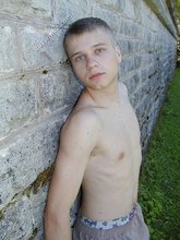Blue-eyed and baby-faced twink undressing outdoors