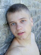 Blue-eyed and baby-faced twink undressing outdoors