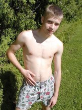 Blue-eyed and baby-faced twink undressing outdoors