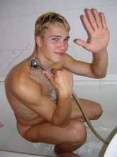 Blond-haired twink flipping off and taking a shower