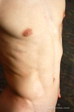 Seductive-looking twink boy shows off his cock and ass