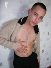 Black pants twink boy is posing indoors and outdoors