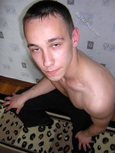 Black pants twink boy is posing indoors and outdoors