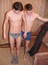 Two twink boyfriends kissing and undressing in the living room