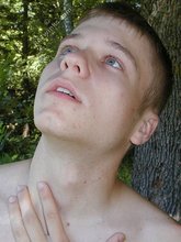Blue-eyed twink boy posing completely naked outdoors