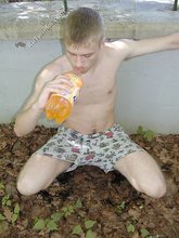 Blue-eyed twink boy posing completely naked outdoors