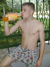 Blue-eyed twink boy posing completely naked outdoors