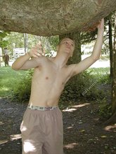 Horny twink with a hairy cock posing naked outdoors