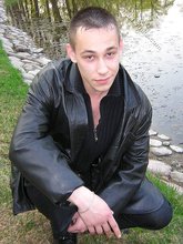 Serious-looking twink takes off his shirt outdoors