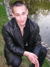Serious-looking twink takes off his shirt outdoors