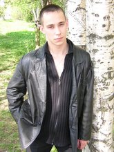 Serious-looking twink takes off his shirt outdoors