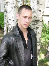 Serious-looking twink takes off his shirt outdoors