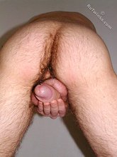 Young boy with brown eyes shows his asshole on all fours