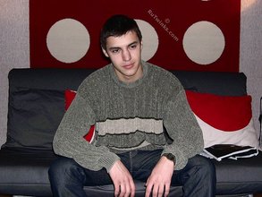 Sweater-wearing brunette boy undressing on camera