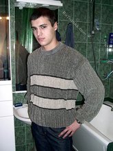 Sweater-wearing brunette boy undressing on camera