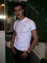 Sweater-wearing brunette boy undressing on camera