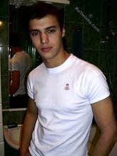 Sweater-wearing brunette boy undressing on camera