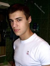 Sweater-wearing brunette boy undressing on camera