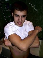 Sweater-wearing brunette boy undressing on camera