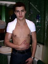 Sweater-wearing brunette boy undressing on camera