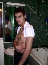 Sweater-wearing brunette boy undressing on camera