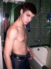 Sweater-wearing brunette boy undressing on camera