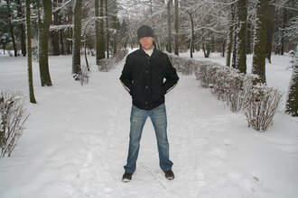 Beautiful young boy posing outdoors with trees