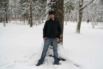 Beautiful young boy posing outdoors with trees
