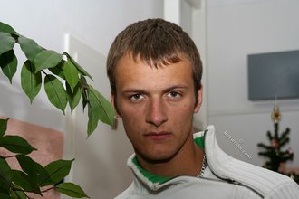 Beautiful young boy posing outdoors with trees