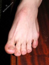Cheerful-looking twink boy shows his cock and hairy ass