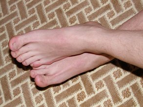 Cheerful-looking twink boy shows his cock and hairy ass